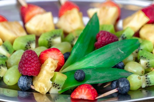 fruit skewers on a tray in celebration.