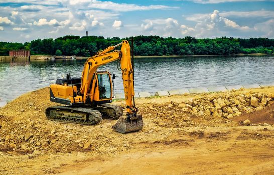 Ruse city, Bulgaria - September 18, 2017, The modern excavator performs excavation work on the construction site in Ruse city, Bulgaria.