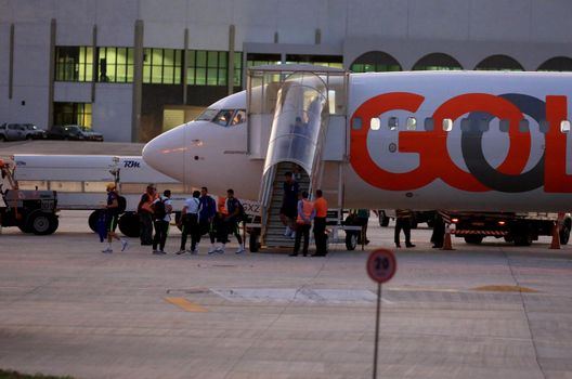 salvador, bahia / brazil - august 8, 2016: passengers of the Gol airline are seen disembarking from the company's aircraft in a remote area of the airport of the city of Salvador.