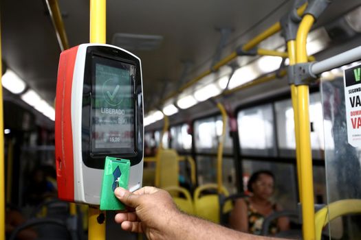 salvador, bahia / brazil - september 8, 2013: Passenger uses card to pay public transport fare when boarding public transport buses in the city of Salvador.