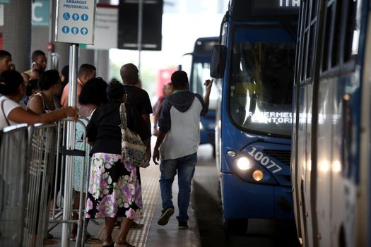 salvador, bahia / brazil - september 8, 2017: Passengers are seen during boarding buses at Estacao Mussurunga in the city of Salvador. The place serves as a transfer station in connection with line 2 of the city's metro.