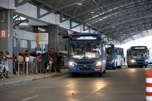 salvador, bahia / brazil - september 8, 2017: Passengers are seen during boarding buses at Estacao Mussurunga in the city of Salvador. The place serves as a transfer station in connection with line 2 of the city's metro.