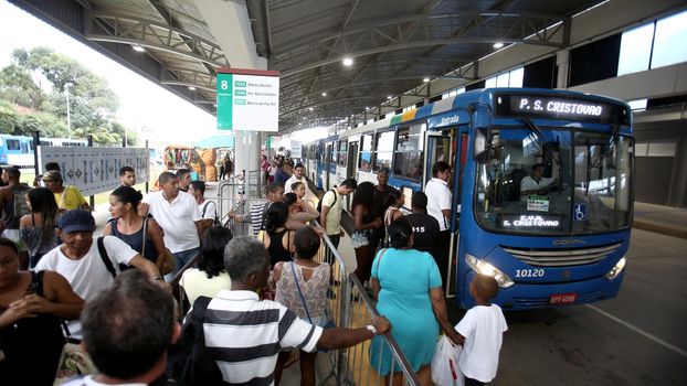 salvador, bahia / brazil - september 8, 2017: Passengers are seen during boarding buses at Estacao Mussurunga in the city of Salvador. The place serves as a transfer station in connection with line 2 of the city's metro.