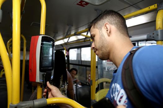 salvador, bahia / brazil - september 8, 2013: Passenger uses card to pay public transport fare when boarding public transport buses in the city of Salvador.