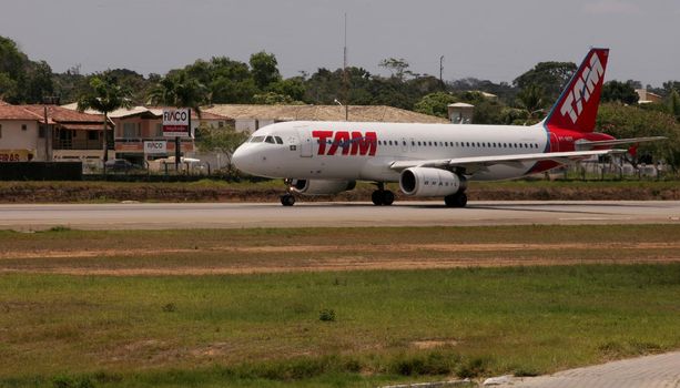 porto seguro, bahia / brazil - november 23, 2010: Airbus A320-232 aircraft from the airline Tam is seen on the patio of the airport in the city of Porto Seguro, in southern Bahia.

