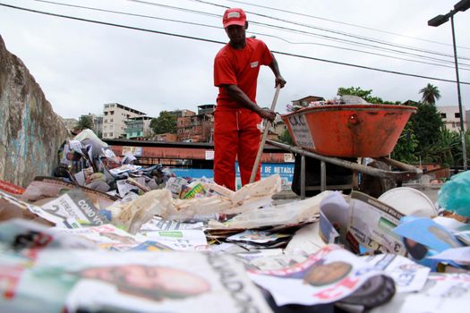 salvador, bahia / brazil - october 8, 2012: Gari is seen collecting electoral propaganda pamphlet paper during elections in the city of Salvador.
