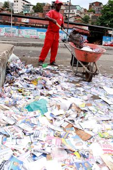 salvador, bahia / brazil - october 8, 2012: Gari is seen collecting electoral propaganda pamphlet paper during elections in the city of Salvador.
