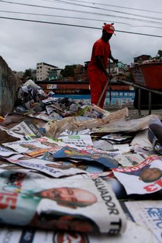 salvador, bahia / brazil - october 8, 2012: Gari is seen collecting electoral propaganda pamphlet paper during elections in the city of Salvador.
