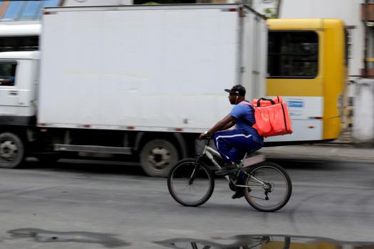 salvador, bahia/brazil - October 8, 2019: Food delivery man rides his bike through the streets of Salvador.