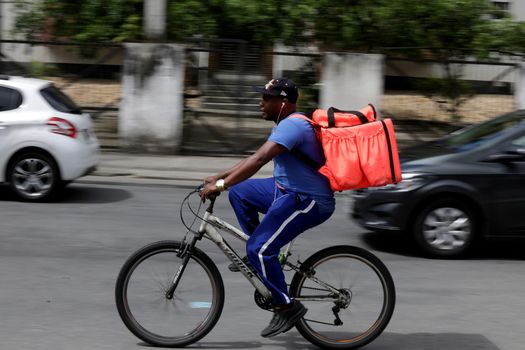salvador, bahia/brazil - October 8, 2019: Food delivery man rides his bike through the streets of Salvador.