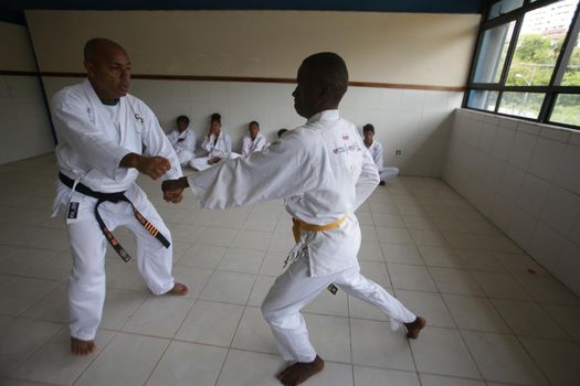 salvador, bahia / brazil - november 8, 2018: public school students from Bairro da Paz in Salvador are seen practicing karate in the school's field.