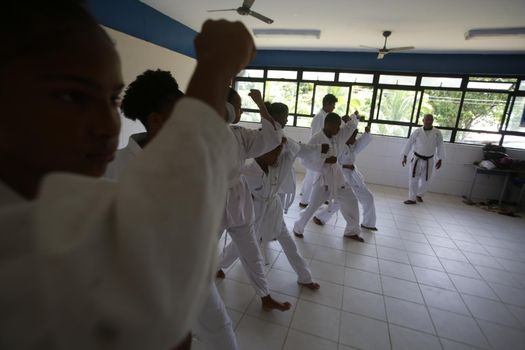 salvador, bahia / brazil - november 8, 2018: public school students from Bairro da Paz in Salvador are seen practicing karate in the school's field.