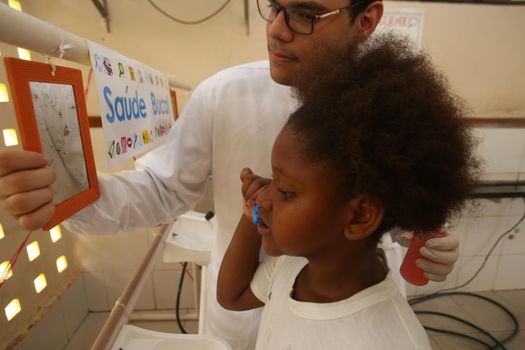 salvador, bahia / brazil - november 8, 2018:  Student of public school in the Bairro da Paz in Salvador learn to brush their teeth during social action. 