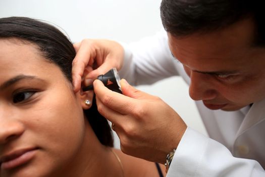 salvador, bahia / brazil - april 10, 2019: otorhino doctor undergoes an otoscopy on a patient in the city of Salvador.