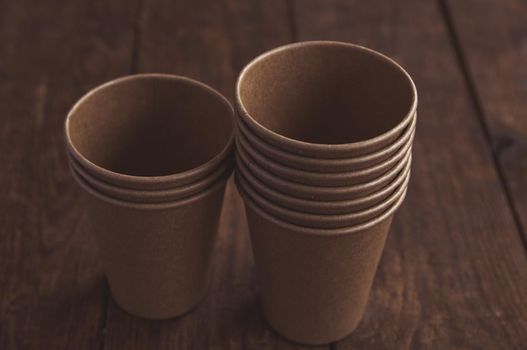 ecological kraft paper cups for coffee and tea dark brown on the table