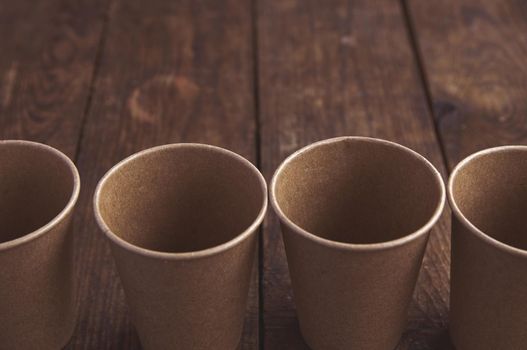 ecological kraft paper cups for coffee and tea dark brown on the table