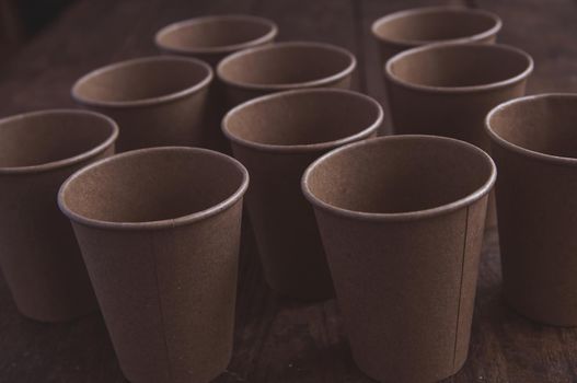 ecological kraft paper cups for coffee and tea dark brown on the table