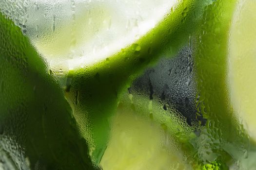 Macro image of a misted chilled glass with a mojito. Food background, texture, selective, focus.