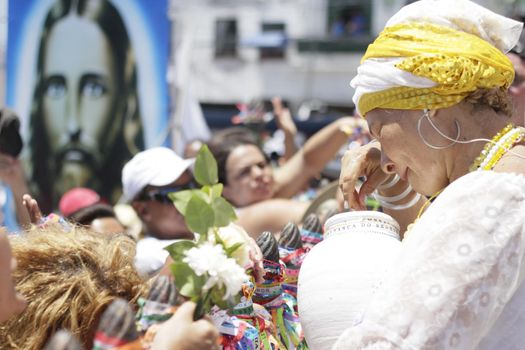 salvador, bahia / brazil - january 15, 2015: Baianas wash the stairs of the Church of Bonfim, during traditional party for Catholics and Candomble fan.