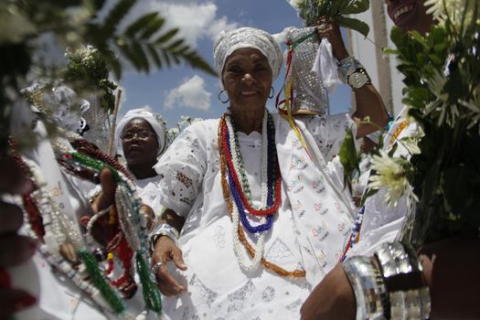 salvador, bahia / brazil - january 15, 2015: Baianas wash the stairs of the Church of Bonfim, during traditional party for Catholics and Candomble fan.