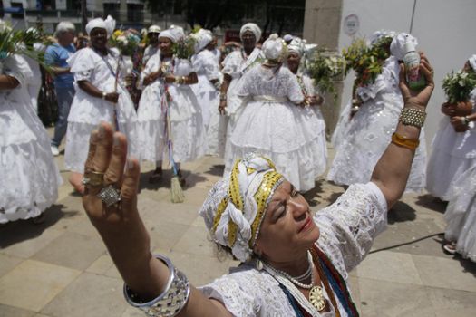 salvador, bahia / brazil - january 15, 2015: Baianas wash the stairs of the Church of Bonfim, during traditional party for Catholics and Candomble fan.