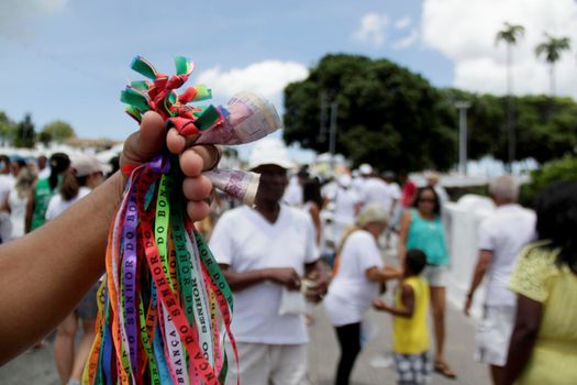 salvador, bahia / brazil - october 4, 2019: Seller of Phytinha is seen at the Senhor do Bonfim church in Salvador city.