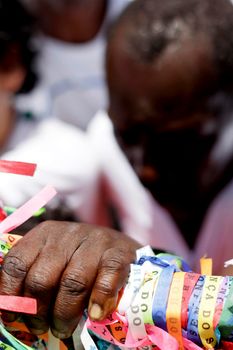 salvador, bahia / brazil - january 15, 2015: person is seen holding tapes of Senhor do Bonfim during religious procession in the church in the city of Salvador.