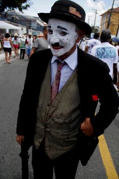 salvador, bahia / brazil - january 15, 2015: character "Bira do Jegue" is seen with Charlie Chaplin costume during a procession to the Church of Bonfim in the city of Salvador.