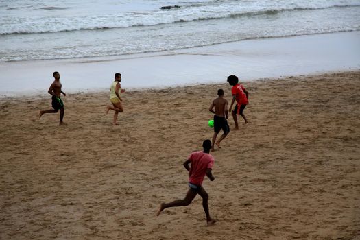 salvador, bahia, brazil - january 15, 2021: people are seen playing football on Ondina beach in the city of Salvador.
