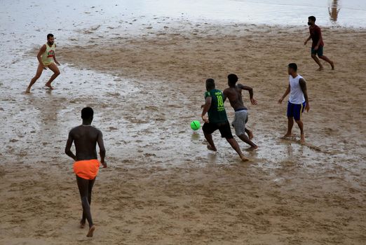 salvador, bahia, brazil - january 15, 2021: people are seen playing football on Ondina beach in the city of Salvador.