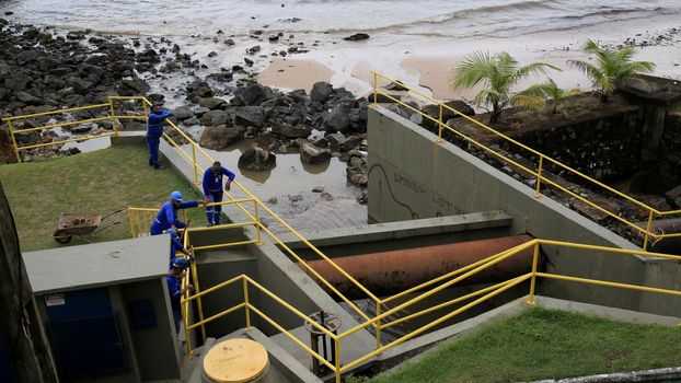 salvador, bahia, brazil - january 15, 2021: workers from Empresa Baiana de Saneamento - Embasa, are seen at a sewage treatment plant on Barra beach in the city of Salvador.