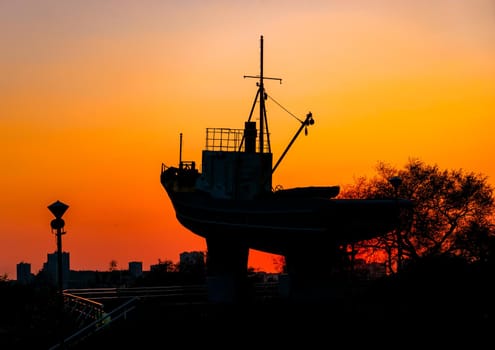 Vladivostok, Russia-September 29, 2019: Silhouette of the monument to the sailors on the background of the sunset.
