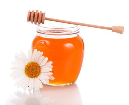 glass pot with floral honey isolated on white background
