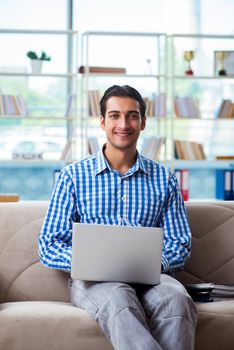 Caucasian student with laptop preparing for university exams 
