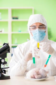 Lab assistant testing GMO chicken
