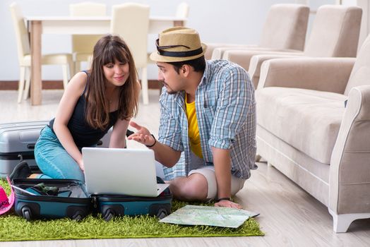 Young pair packing for summer vacation travel