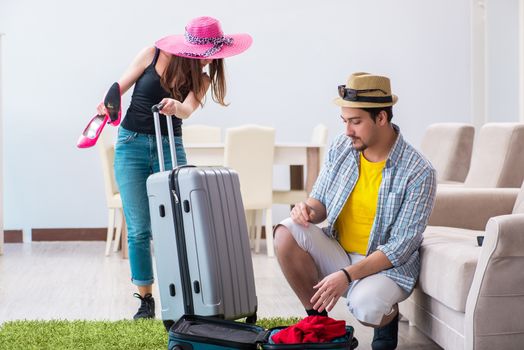 Young family packing for vacation travel