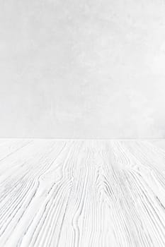 Empty white wooden surface against gray decorative plaster or concrete background. Mockup for design.