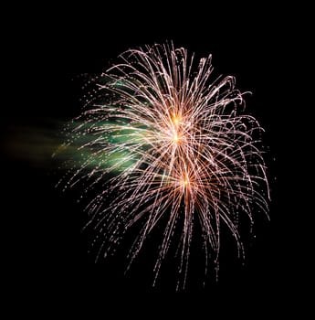 Colorful fireworks isolated on black sky background.