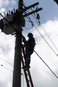 salvador, bahia / brazil - february 28, 2019: Electrician makes repairs to the power grid during the Carnival period in Salvador.