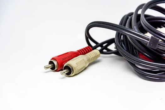 Two red and white audio RCA plugs isolated on a white background. Analog technology. Commonly used to carry audio and video signals