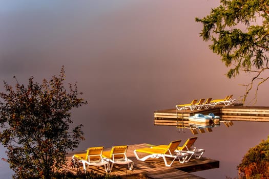 view of a boat dock the Lac-Superieur, misty morning with fog, in Laurentides, Mont-tremblant, Quebec, Canada