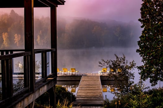 view of a boat dock the Lac-Superieur, misty morning with fog, in Laurentides, Mont-tremblant, Quebec, Canada