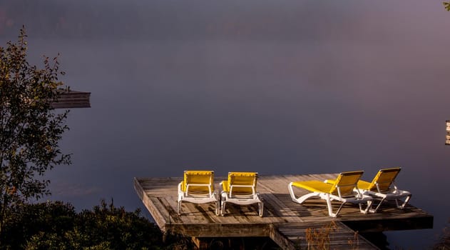 view of a boat dock the Lac-Superieur, misty morning with fog, in Laurentides, Mont-tremblant, Quebec, Canada