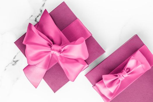 Birthday, wedding and girly branding concept - Pink gift box with silk bow on marble background, girl baby shower present and glamour fashion gift for luxury beauty brand, holiday flatlay art design