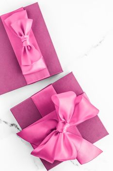 Birthday, wedding and girly branding concept - Pink gift box with silk bow on marble background, girl baby shower present and glamour fashion gift for luxury beauty brand, holiday flatlay art design