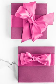 Birthday, wedding and girly branding concept - Pink gift box with silk bow on marble background, girl baby shower present and glamour fashion gift for luxury beauty brand, holiday flatlay art design