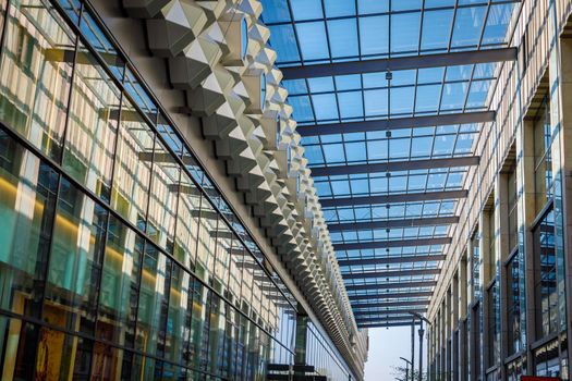 Glass roof with geometric metal partitions. Rows under the roof.