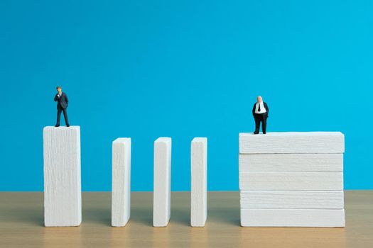 Business strategy conceptual photo - Miniature of businessman stands at the edge of wooden bridge staircase. Image photo