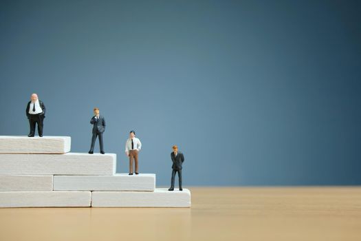 Business strategy conceptual photo - Miniature of businessman stands on a podium. Image photo